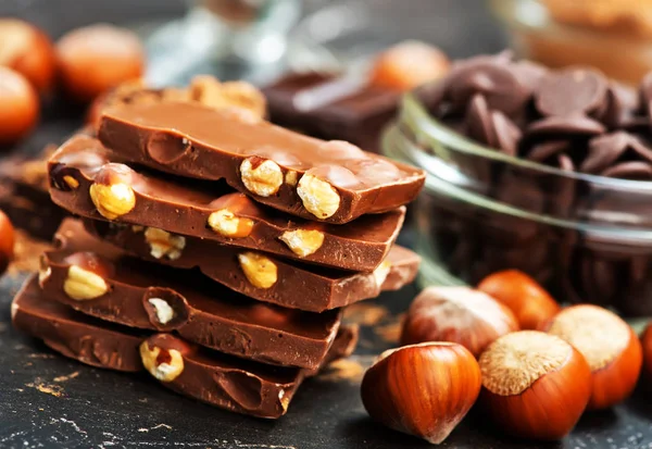 Chocolate bars and nuts — Stock Photo, Image