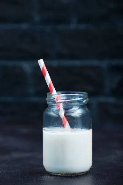 Milk in glass with straw — Stock Photo, Image