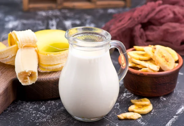 Melk in glazen pot en bananen — Stockfoto