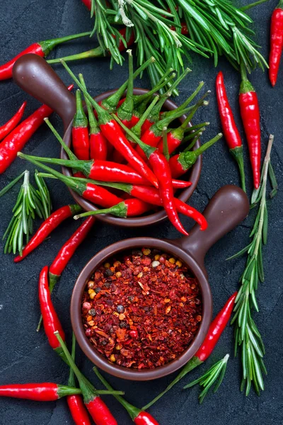 Chilli peppers on the black table, — Stock Photo, Image