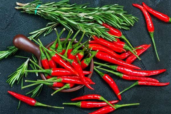 Chilli peppers on the black table, — Stock Photo, Image