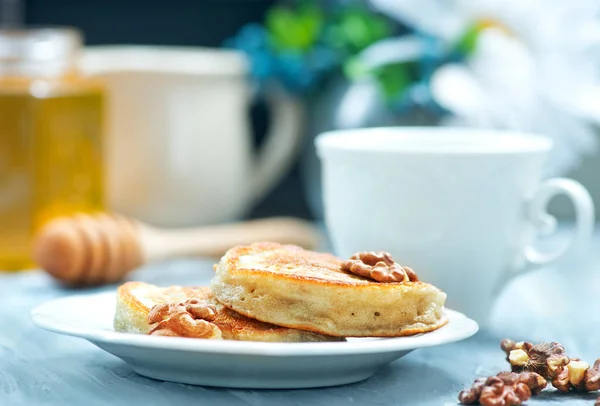 Pancakes with nuts on table — Stock Photo, Image
