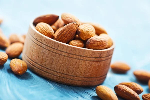 Dry almonds in wooden bowl — Stock Photo, Image