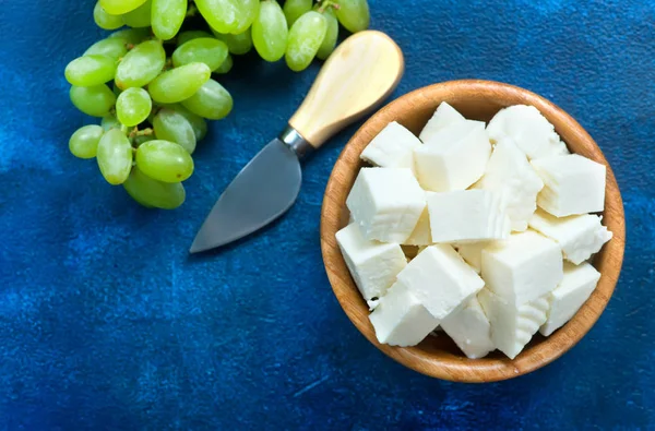 Cheese in bowl with grapes — Stock Photo, Image