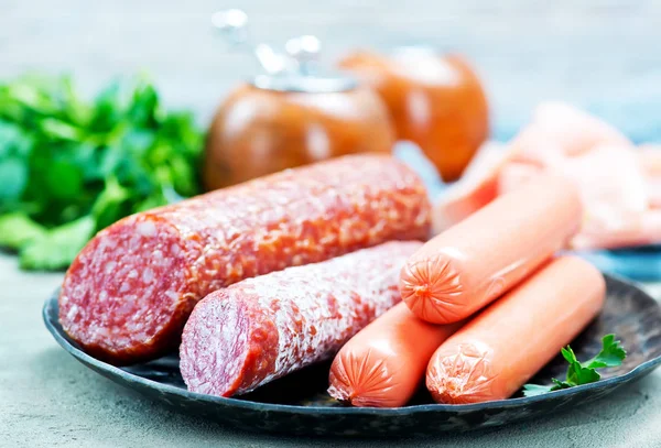 Sausages and salamni on plate — Stock Photo, Image