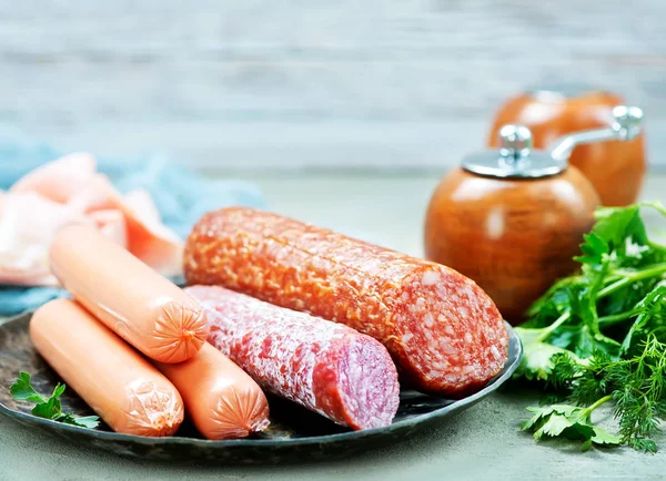 Sausages and salamni on plate — Stock Photo, Image