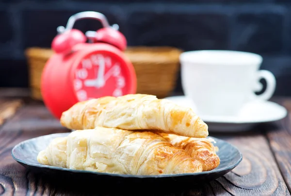 Croissants on black plate — Stock Photo, Image