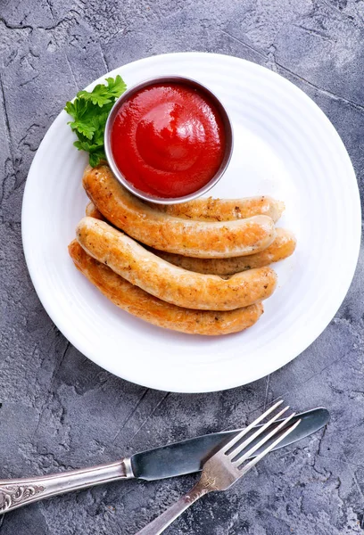 Delicious sausages with sauce — Stock Photo, Image