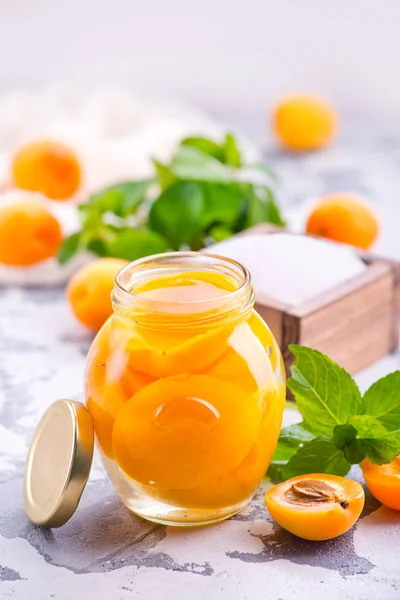 Apricots with jam in glass bank — Stock Photo, Image