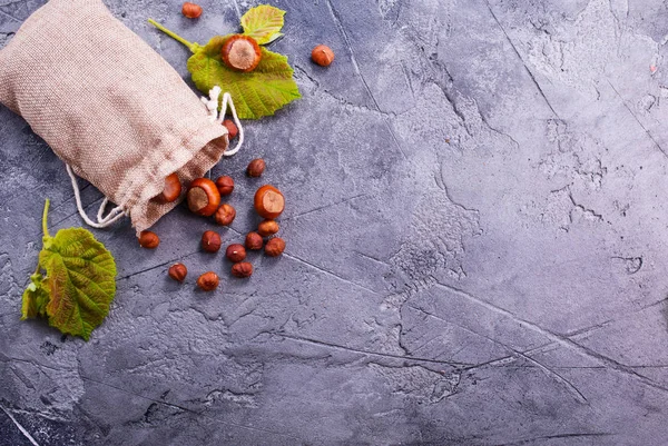 Bag with hazelnuts on table — Stock Photo, Image