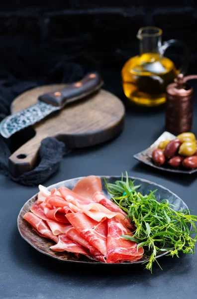 prosciutto on plate with herbs