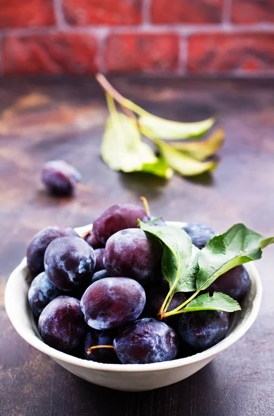 Fresh plums on table — Stock Photo, Image