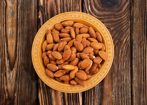 Fried almond on wooden table — Stock Photo, Image