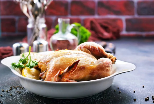 Baked chicken on white plate and on a table — Stock Image Baked Chicken White Plate Table Stock Picture