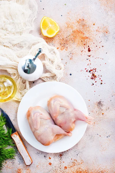 Raw quails in white plate — Stock Photo, Image