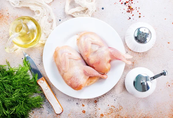 Raw quails in white plate — Stock Photo, Image