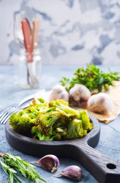 Broccoli with spices on wooden board — Stock Photo, Image