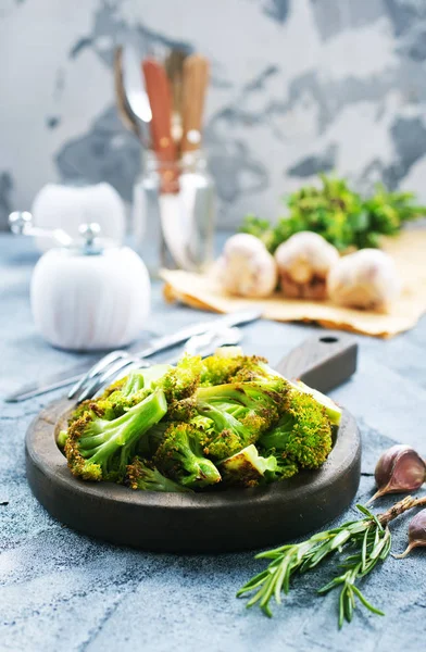 Broccoli with spices on wooden board — Stock Photo, Image