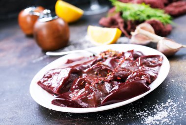 pişmemiş karaciğer koyu arka plan üzerinde tabakta görmek 