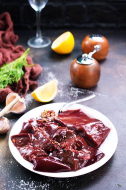 pişmemiş karaciğer koyu arka plan üzerinde tabakta görmek 