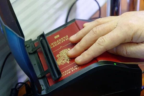 Scanning a Russian passport for border control at the Ukrainian checkpoint