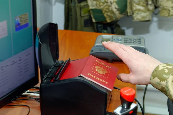 Scanning a Russian passport for border control at the Ukrainian checkpoint