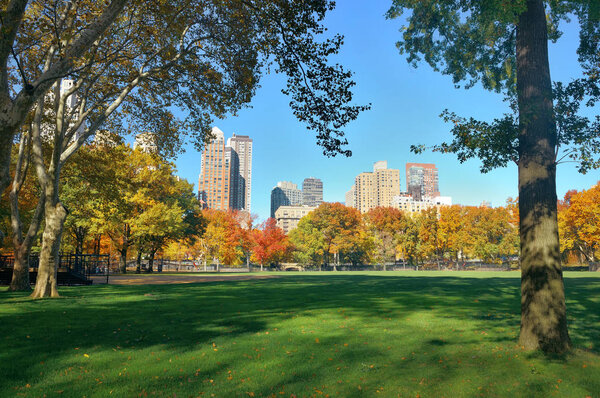 Manhattan midtown skyline viewed from central park in Autumn in New York City.