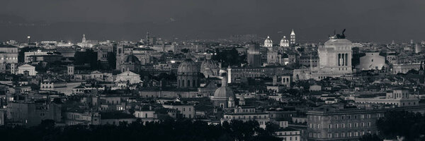 Rome rooftop panorama view with skyline and ancient architecture in Italy at night.