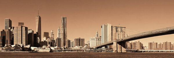 Manhattan financial district with skyscrapers and Brooklyn Bridge.