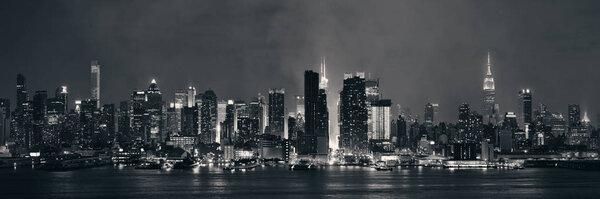 Manhattan midtown skyscrapers and New York City skyline panorama at night with fog