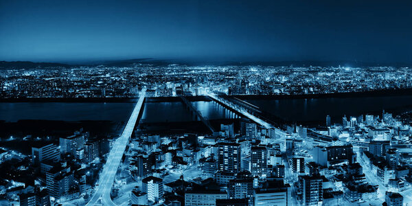 Osaka urban city at night rooftop panoramic view. Japan.