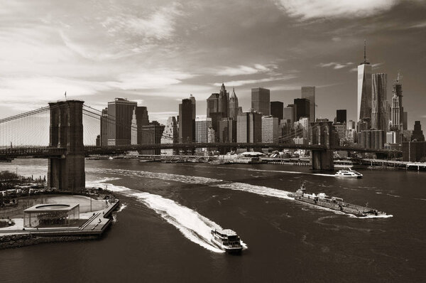 Brooklyn Bridge and downtown Manhattan skyline with boat in New York City