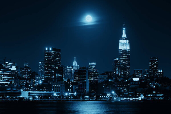 Moon rise over midtown Manhattan with city skyline at night