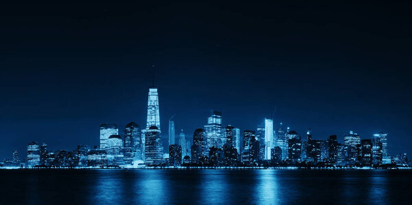 New York City downtown skyline at night panorama over Hudson River