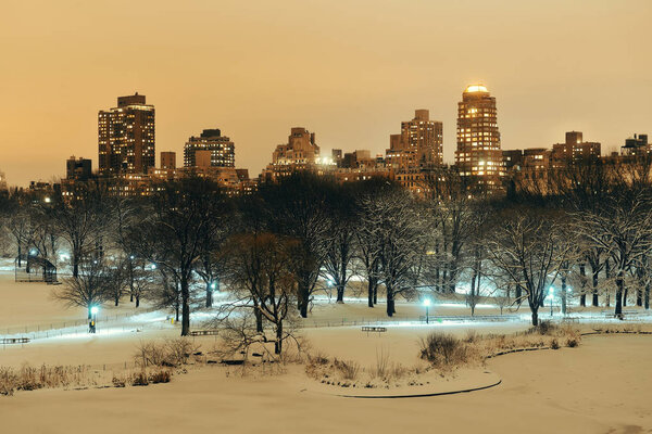 Central Park in winter at night with skyscrapers in midtown Manhattan, New York City