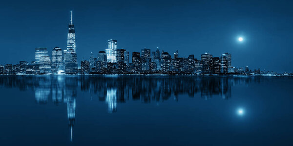 New York City at night with urban architectures reflections