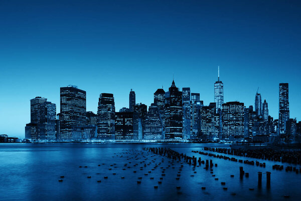 New York City downtown skyline with pier remains at dusk