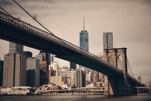 Below Brooklyn Bridge with downtown Manhattan skyline in New York City