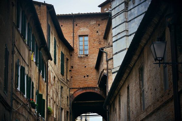 Siena street view with old buildings in Italy