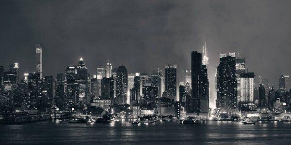 Manhattan panorama midtown skyscrapers and New York City skyline at night with fog