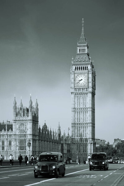 Vintage taxi on Westminster Bridge with Big Ben in London. Black and white