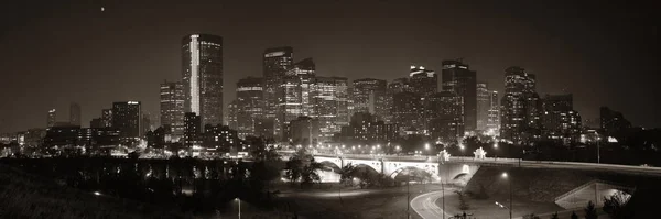 Calgary downtown cityscape with skyscraper and bridge at night, Canada.