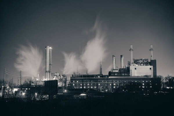 Factory with chimney at night in Philadelphia.