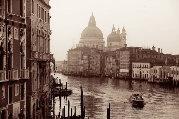 Church Santa Maria della Salute and Grand Canal view in monochrome with boat, Venice, Italy.