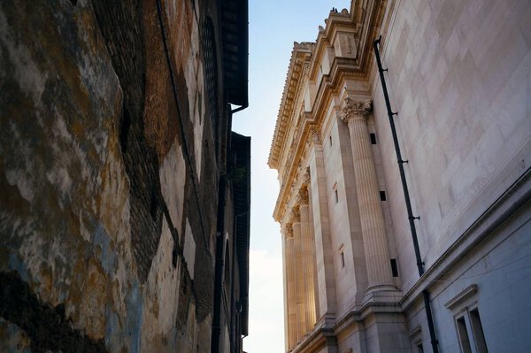 Alley with old buildings and National Monument to Victor Emmanuel II in Rome, Italy.