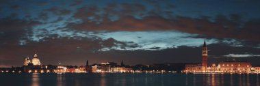 Venedik geceleri gökyüzü Santa Maria della Salute Kilisesi ve saat kulesi İtalya 'nın tarihi mimarisi.