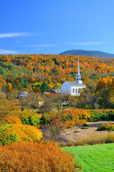 Stowe in Autumn with colorful foliage and community church in Vermont