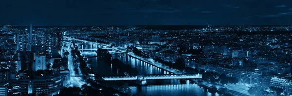 Paris city skyline rooftop view with River Seine at night, France.