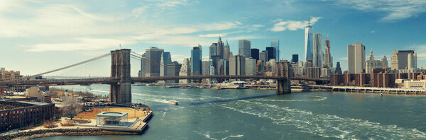 Brooklyn Bridge and downtown Manhattan skyline with boat in New York City