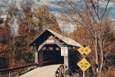 Covered bridge in Vermont in Autumn clipart